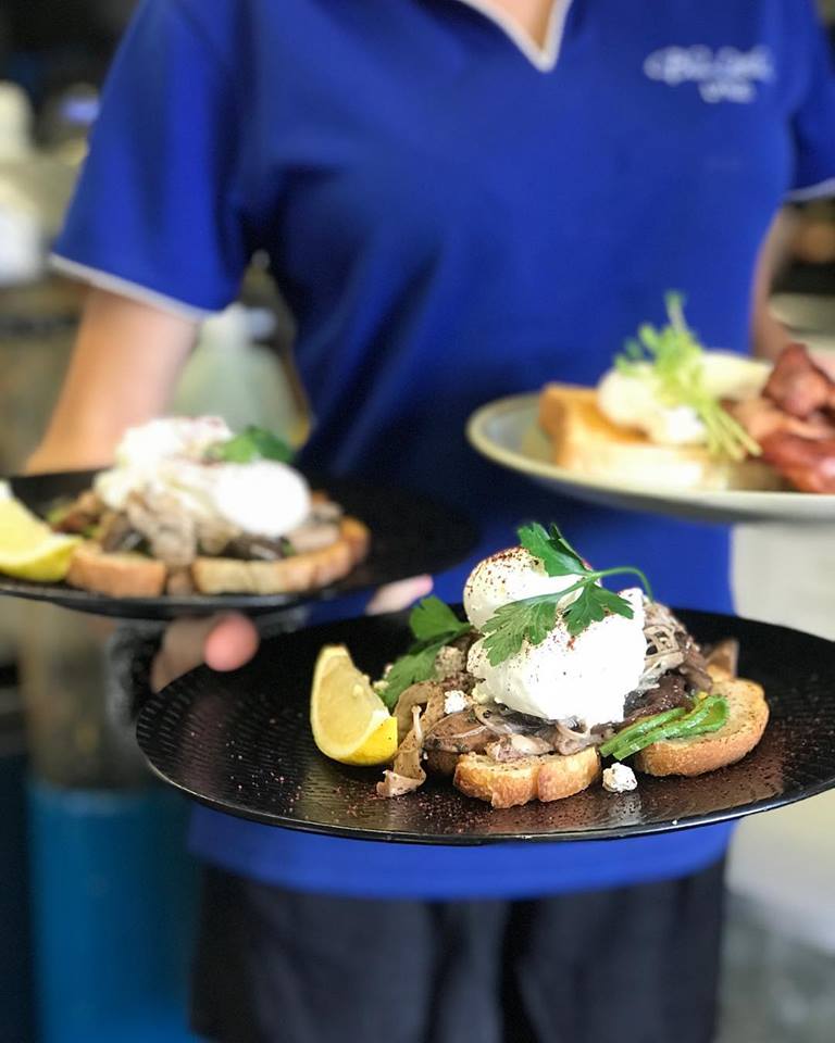 Bluebottles Brasserie Waitress holding plates of food