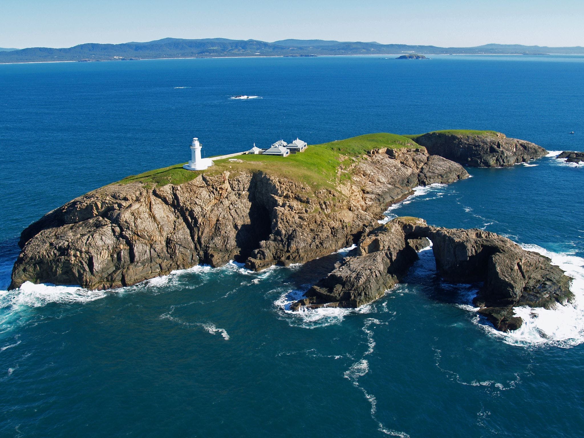 South Solitary Island with lighthouse and keepers quarters in view on a bluebird day