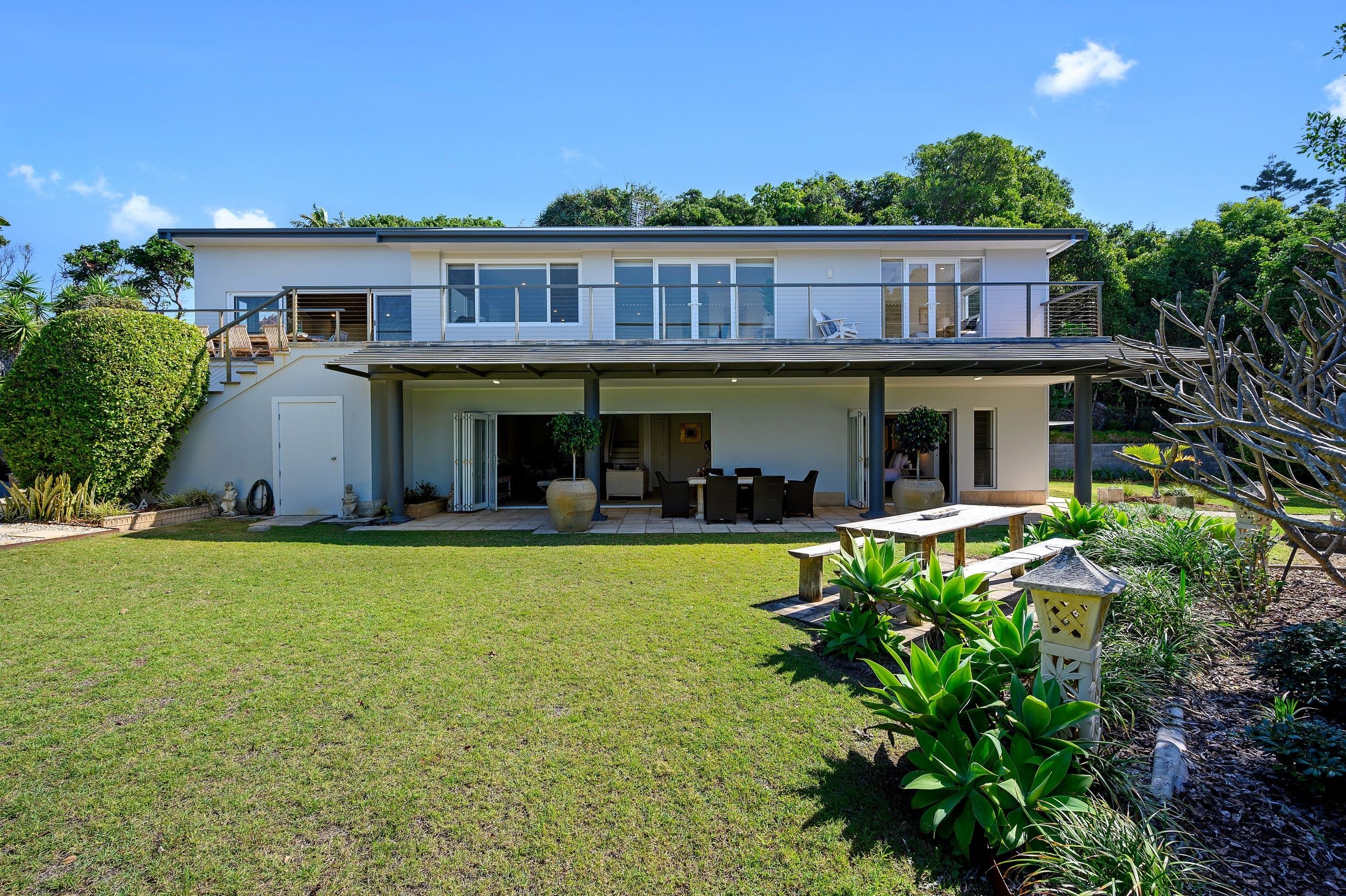 Exterior of house, set in private gardens with private pathway to beach