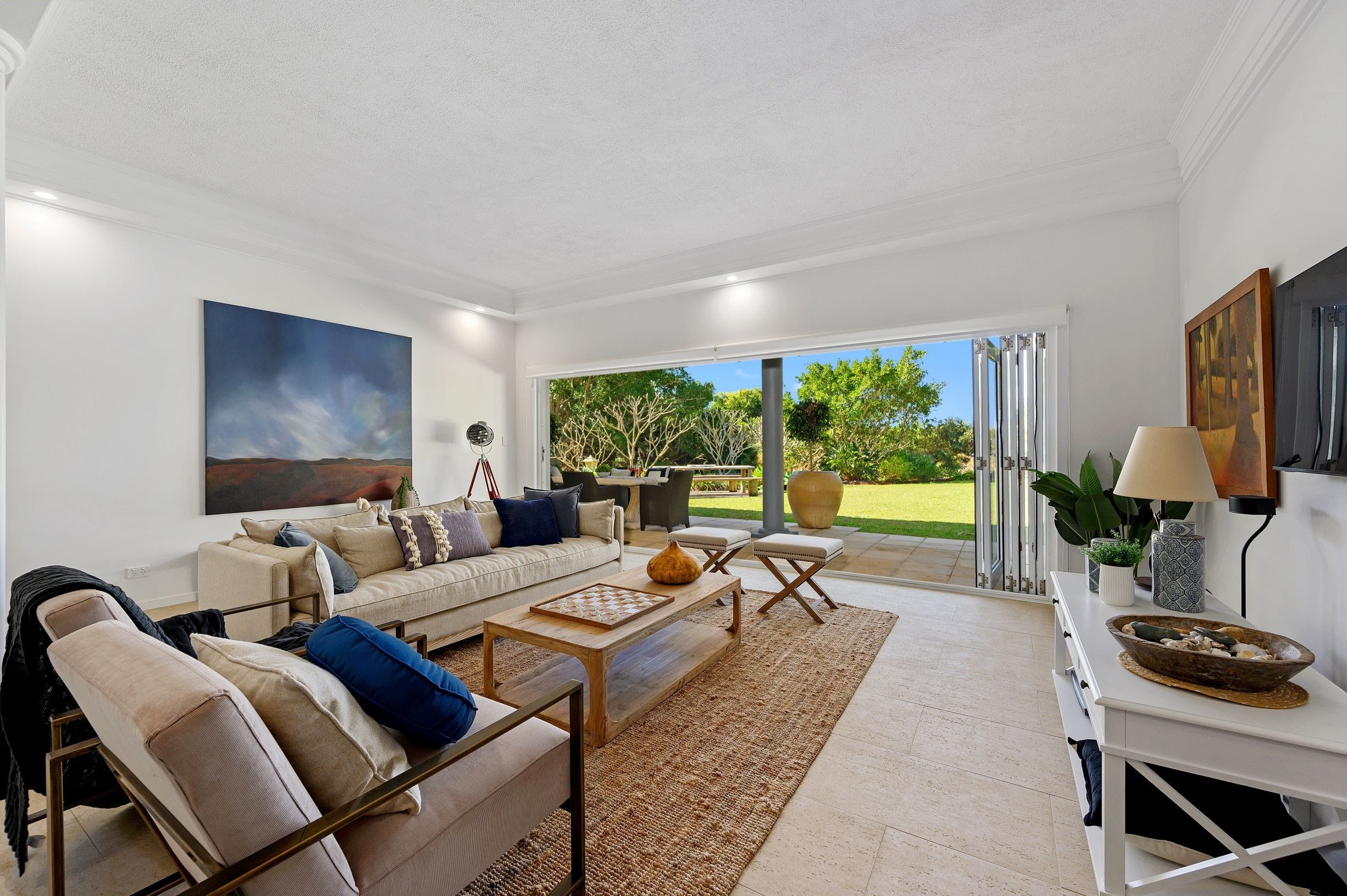 Luxury lounge on lower level flowing onto alfresco dining area and lawn