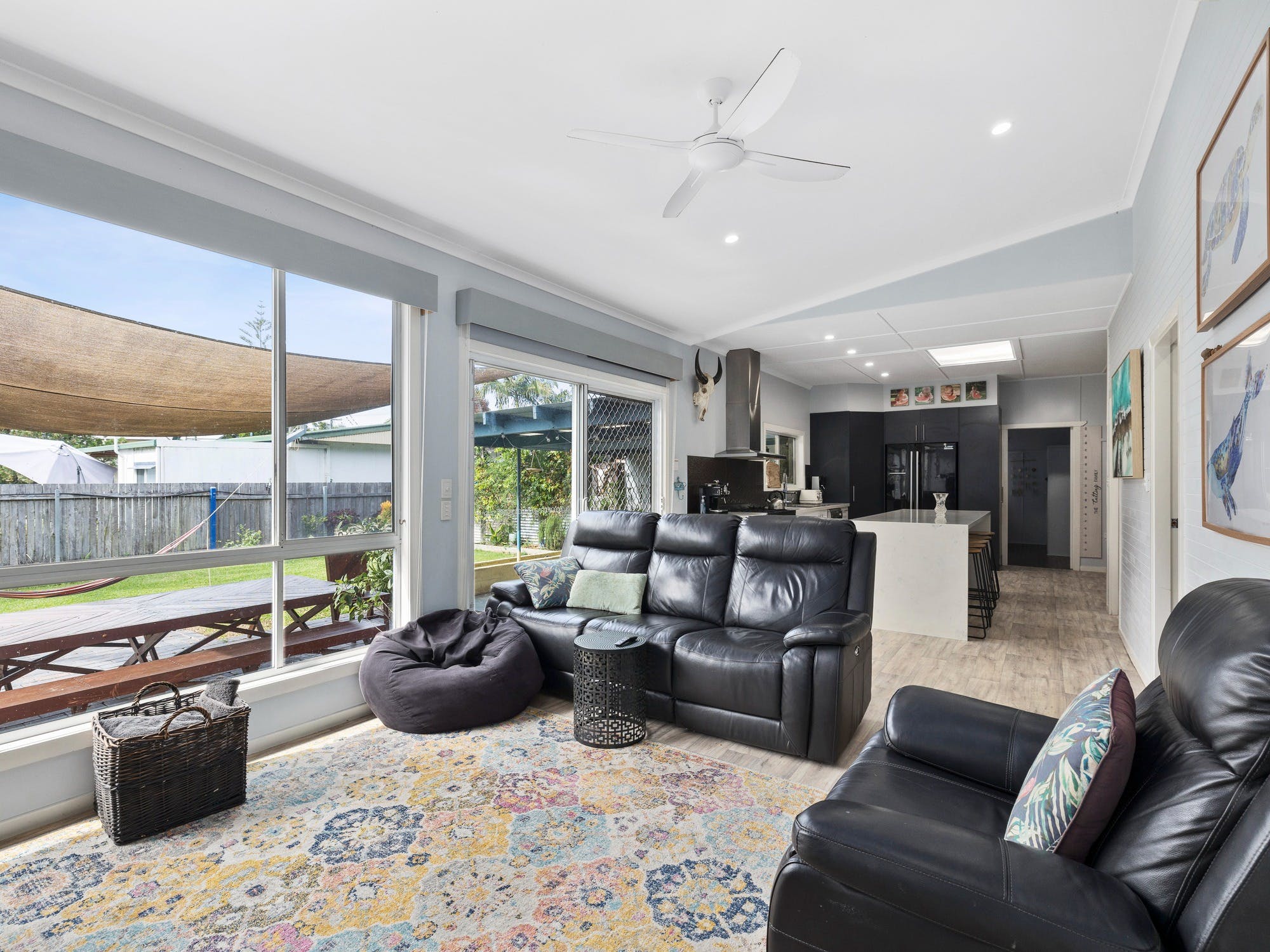 Open plan lounge with comfy seating and TV