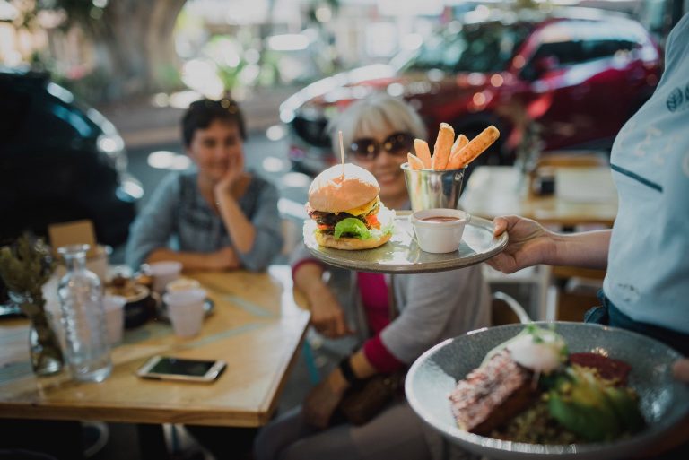 Delicious burger delivered to the table