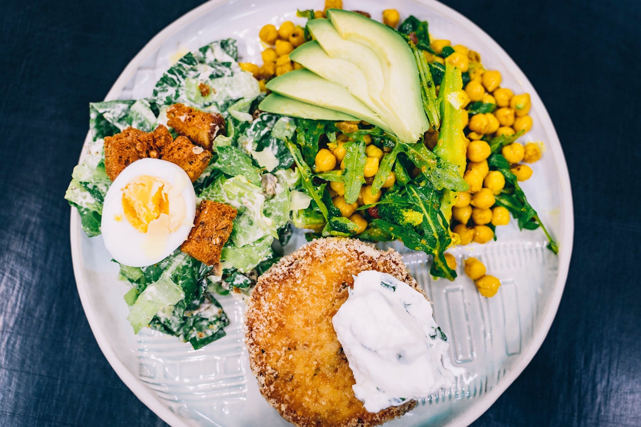 A vegetarian pattie with salad on a plate