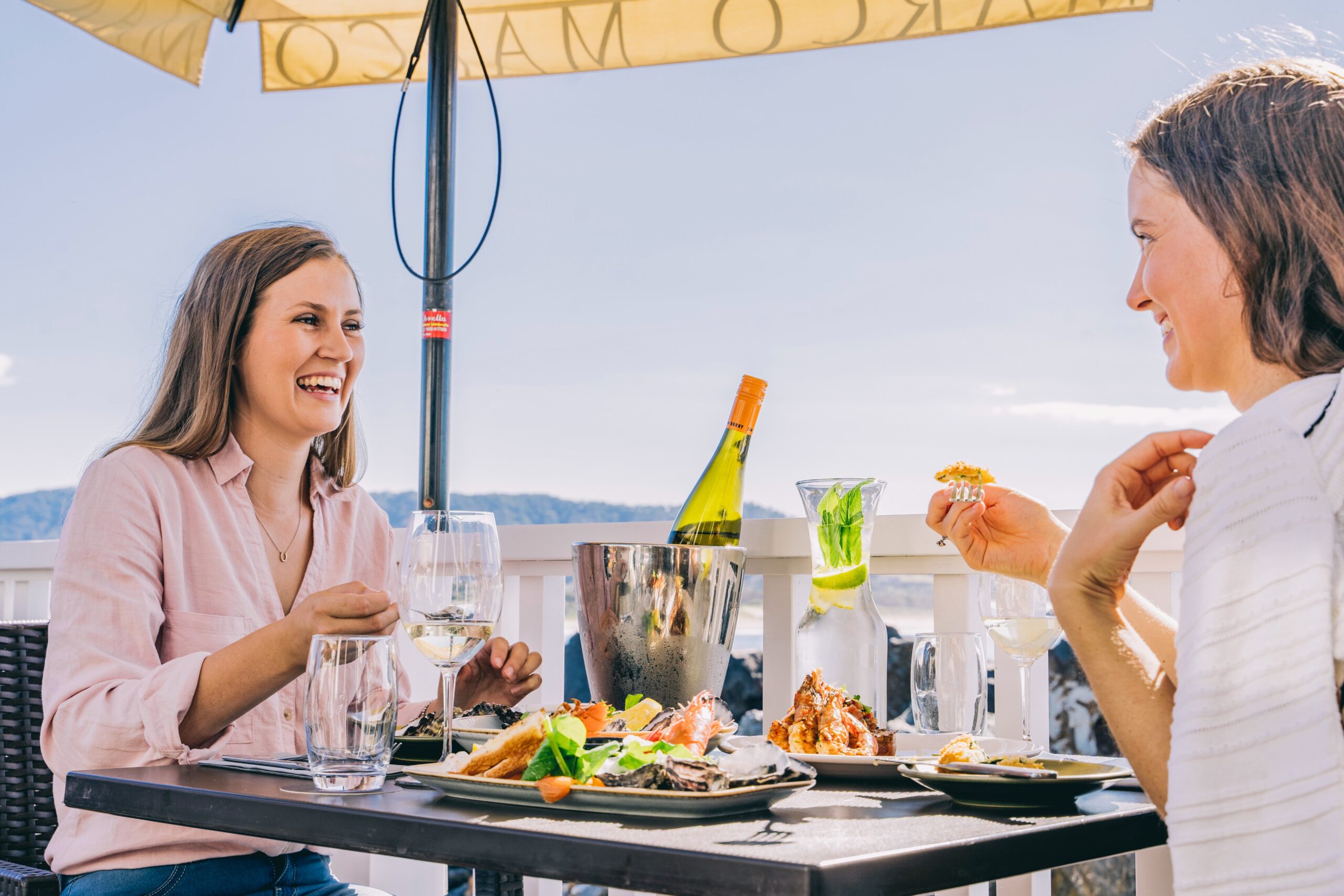 Friends enjoying food and drink at Latitude 30, Coffs Harbour