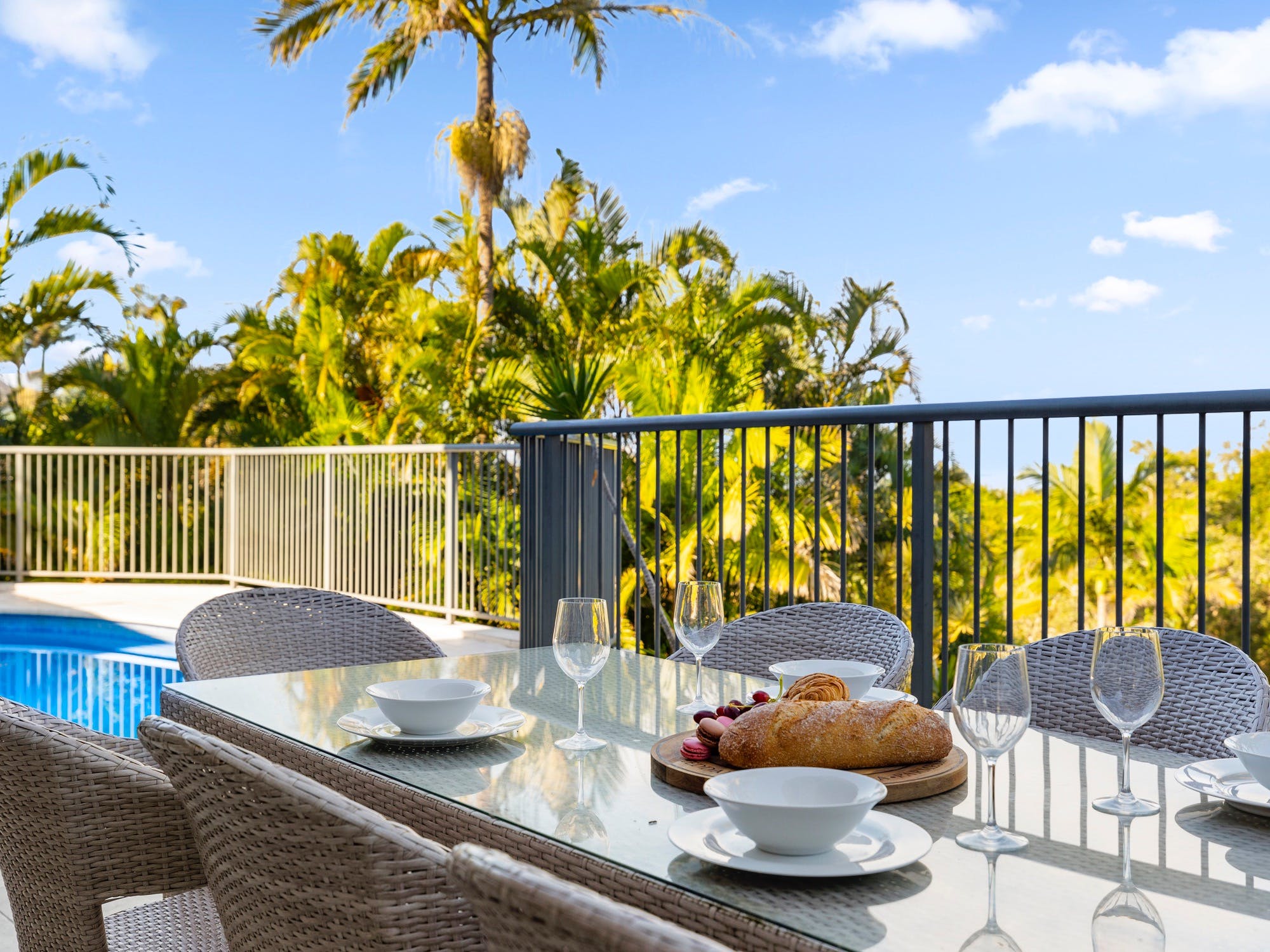 Outdoor dining with BBQ and pool views