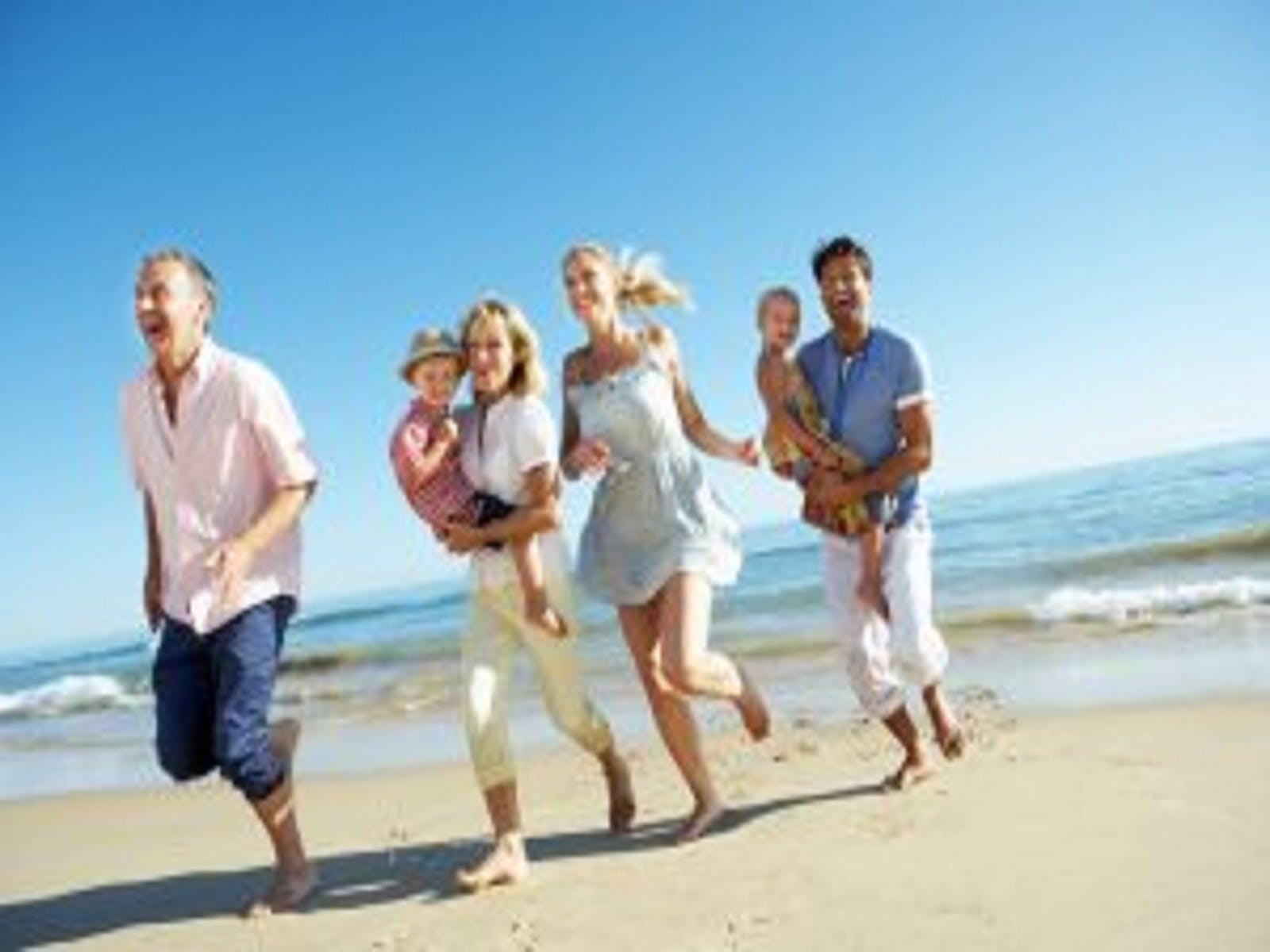 family playing on the beach