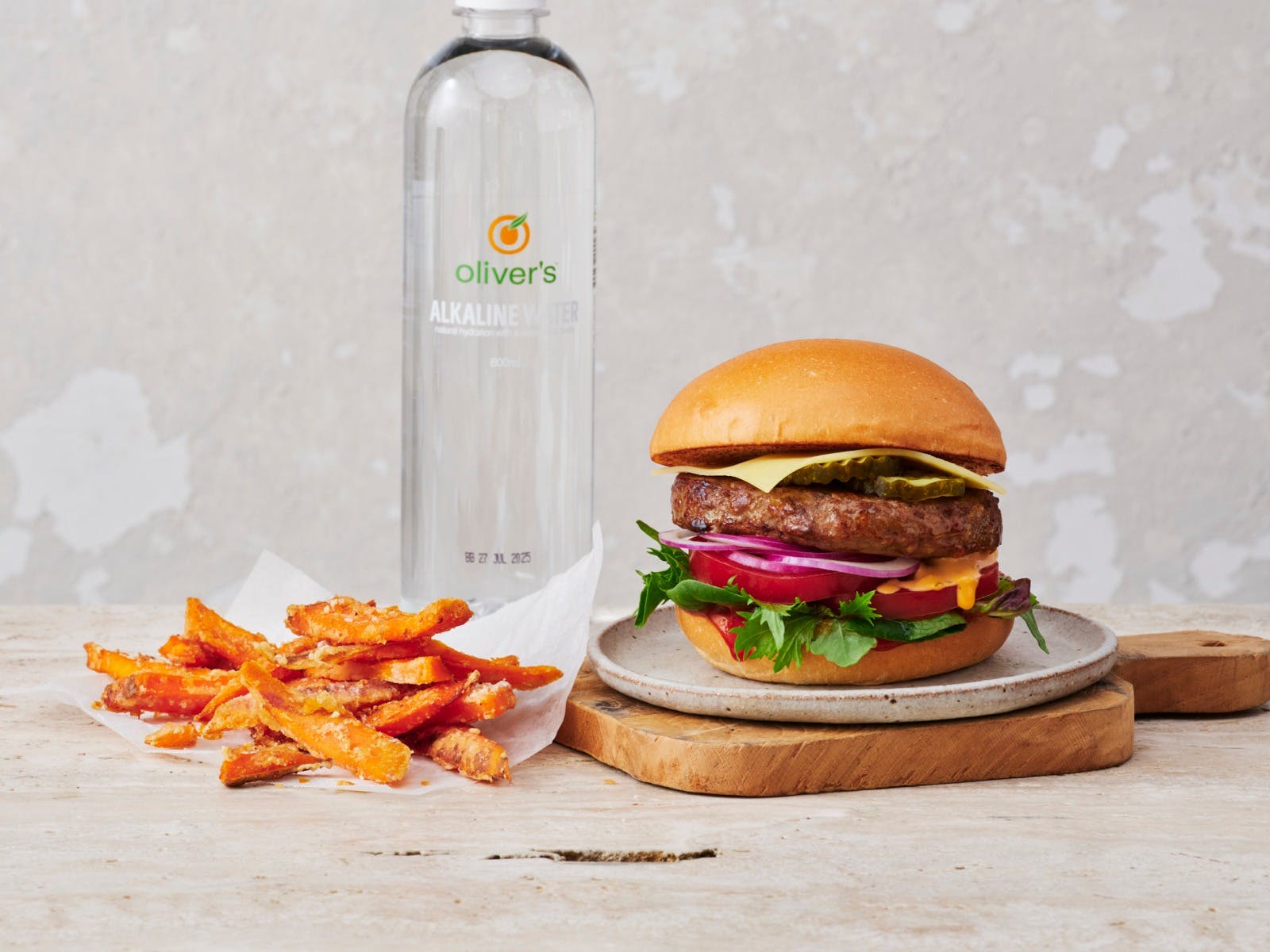 Oliver's beef burger meal, with sweet potato chips and water