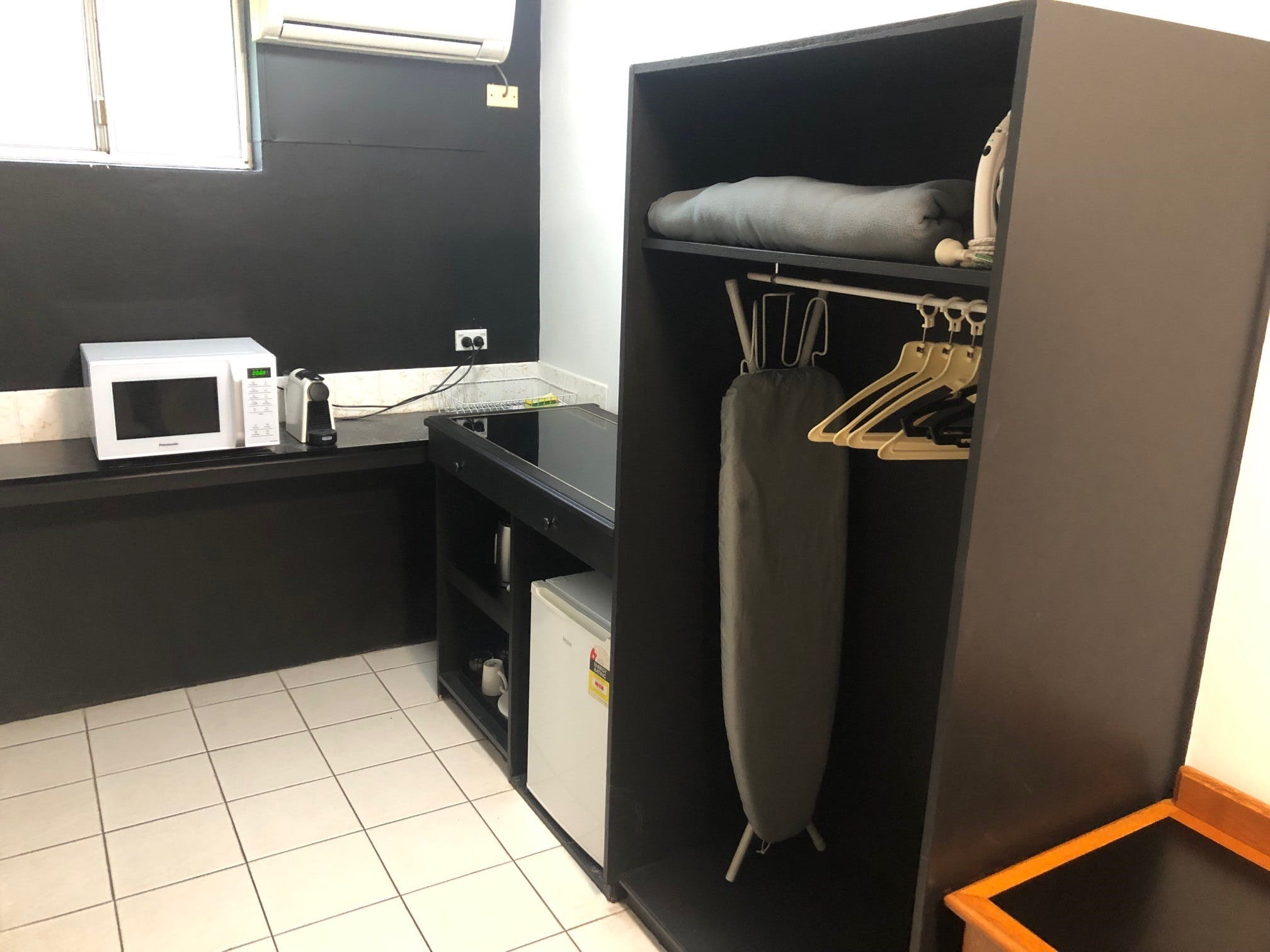 Bar fridge, microwave, coffee machine, toaster, kettle, crockery & cutlery, plus iron & board.