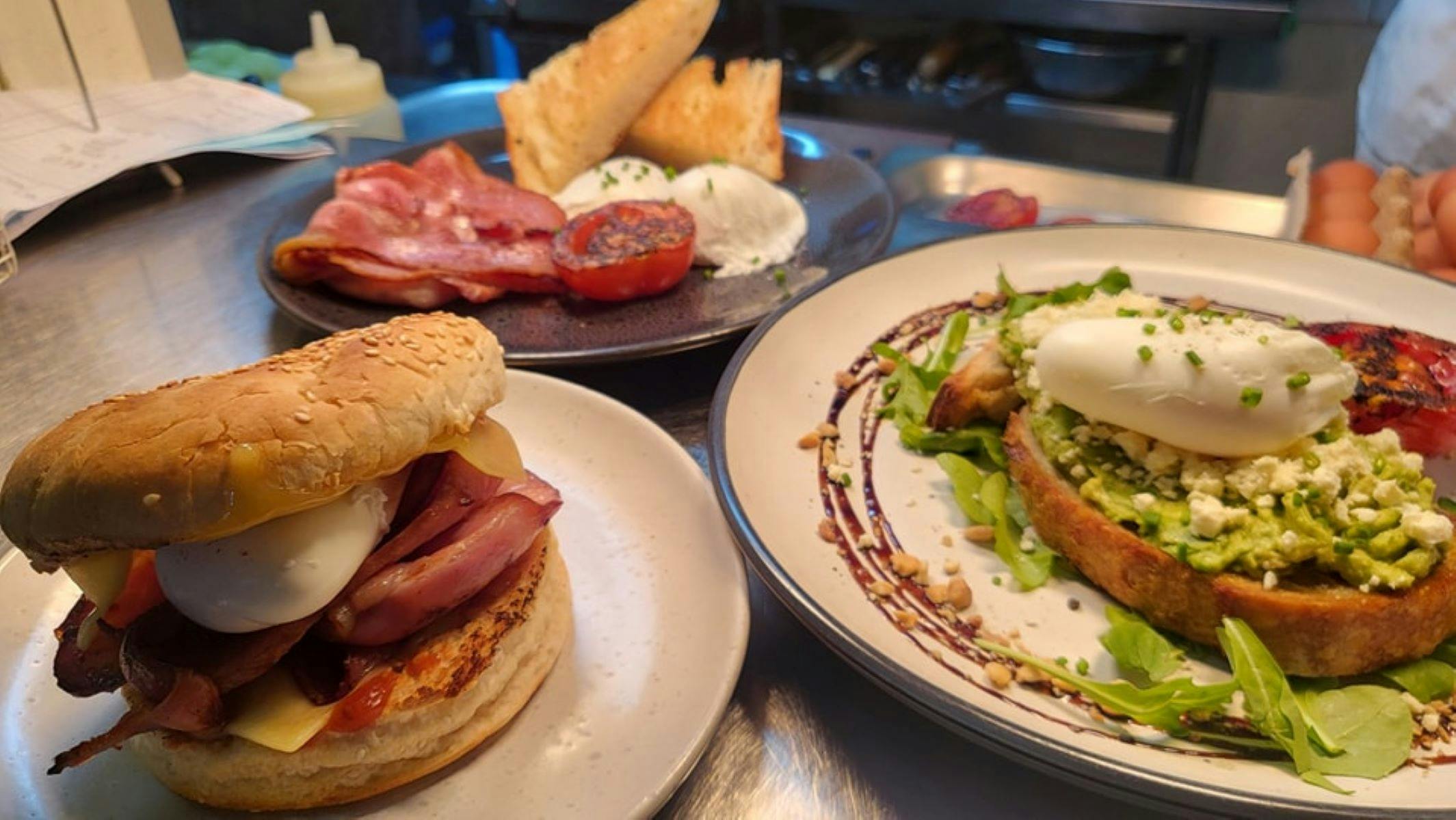 Breaky Burger, Bacon & Eggs poached with turkish  and Avocado smash on sourdough with dukkha & fett