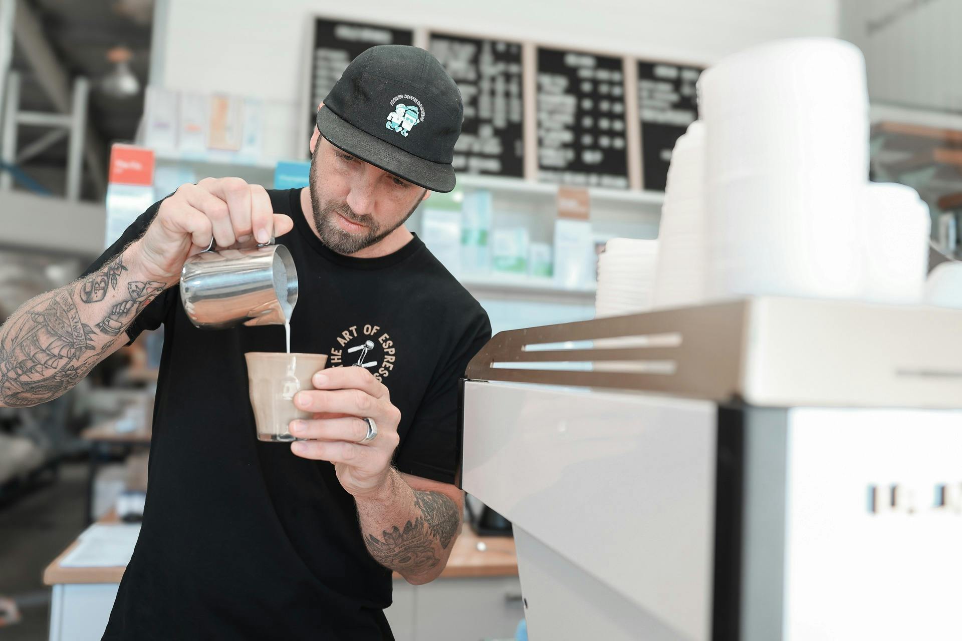 Barista Jimmy Evans pouring a latte in the Artisti Espresso Bar.